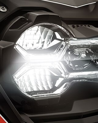 We see the front headlight of the R 1250 GS Adventure.