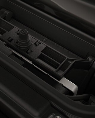 Integrated charging compartment with mobile phone.